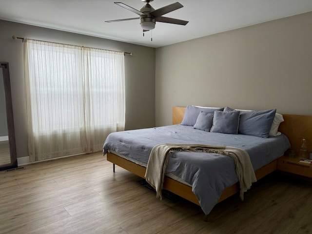 bedroom featuring hardwood / wood-style floors and ceiling fan