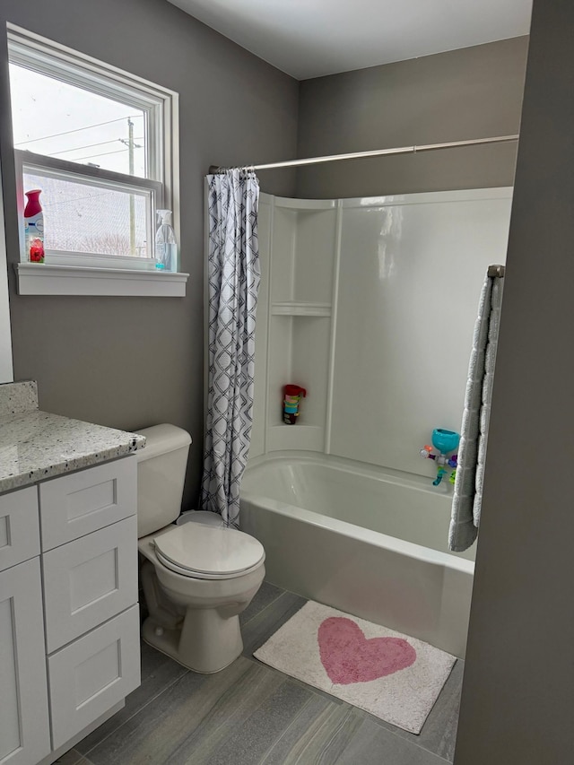 full bathroom with shower / tub combo, vanity, hardwood / wood-style flooring, and toilet