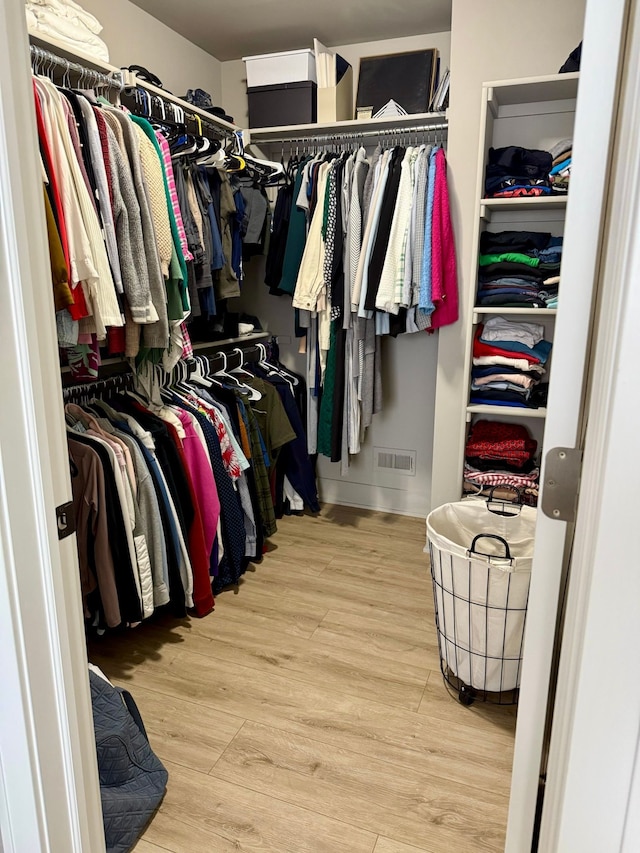 walk in closet featuring light hardwood / wood-style flooring