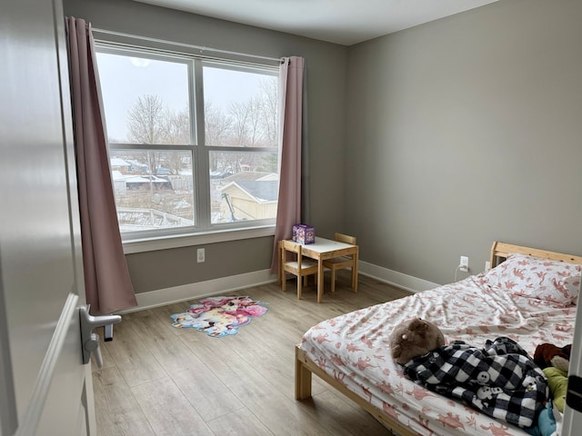 bedroom with hardwood / wood-style floors