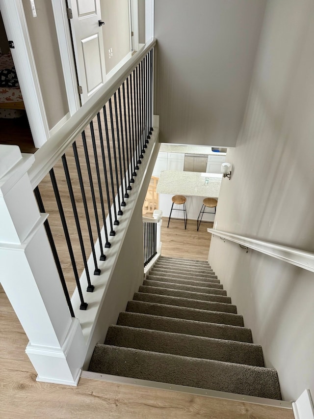 stairway featuring hardwood / wood-style flooring