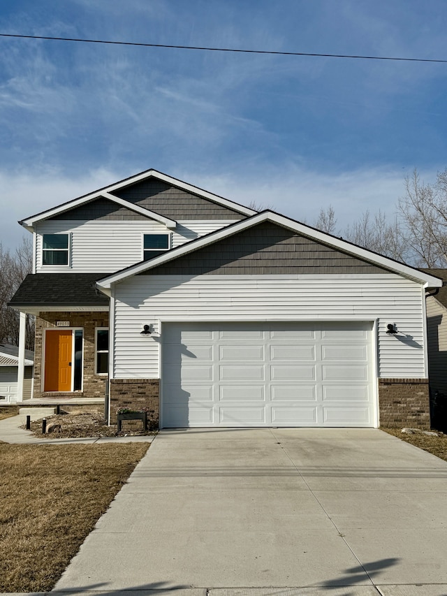 view of front facade featuring brick siding, driveway, and a garage