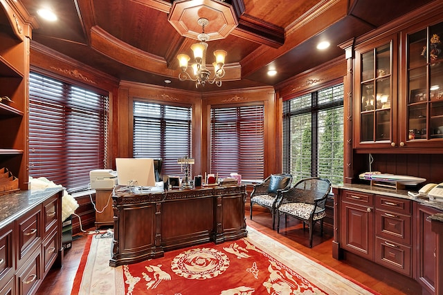 office space featuring a notable chandelier, ornamental molding, light wood-type flooring, coffered ceiling, and beamed ceiling