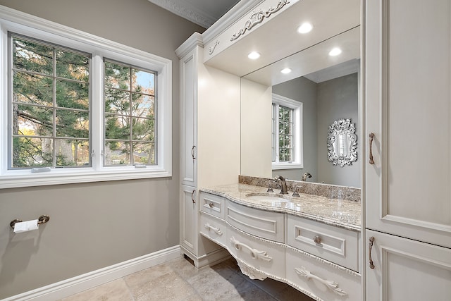 bathroom with ornamental molding and vanity