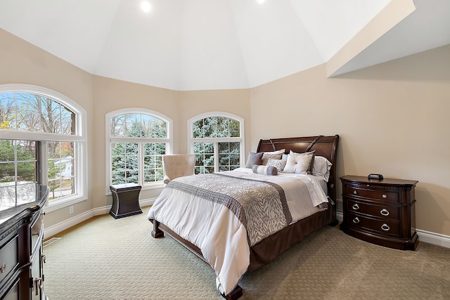 bedroom with high vaulted ceiling, light carpet, visible vents, and baseboards