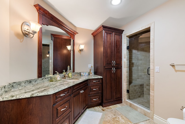 bathroom featuring walk in shower and vanity