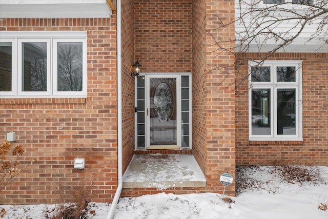 view of snow covered property entrance