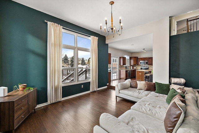 living room featuring dark hardwood / wood-style floors and a chandelier