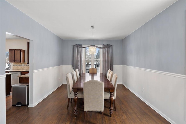 dining space featuring dark hardwood / wood-style floors and a notable chandelier