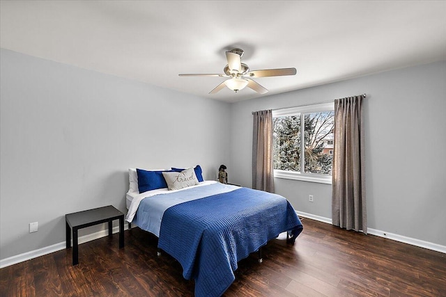 bedroom with dark hardwood / wood-style flooring and ceiling fan