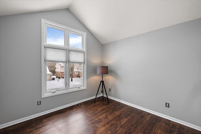 unfurnished room with lofted ceiling and dark hardwood / wood-style floors