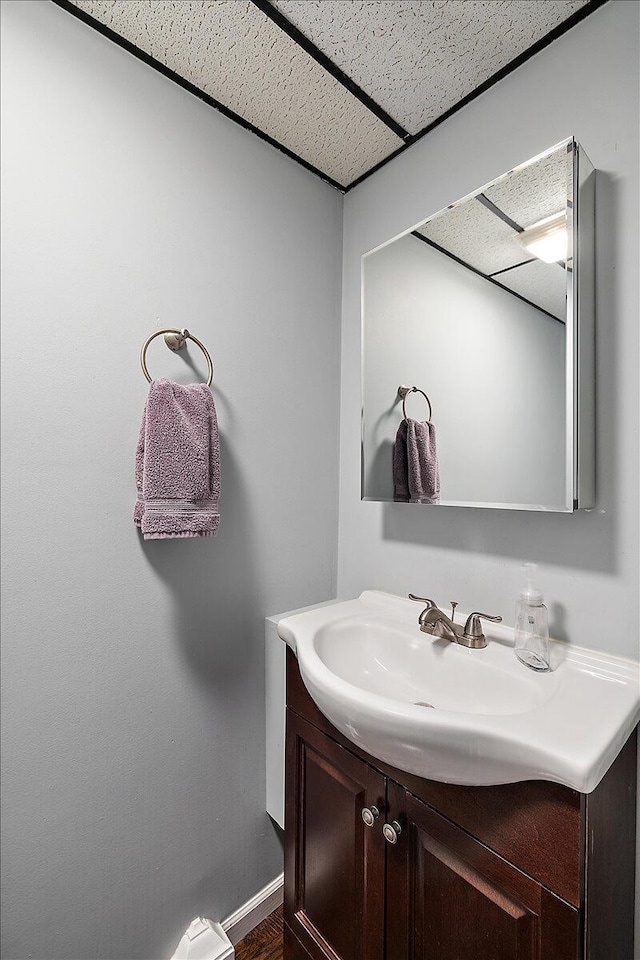 bathroom with vanity and a paneled ceiling