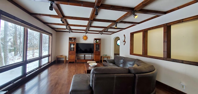 living room featuring dark wood-type flooring, coffered ceiling, and beamed ceiling