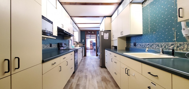 kitchen with sink, stainless steel fridge, white cabinetry, range with electric stovetop, and light hardwood / wood-style floors