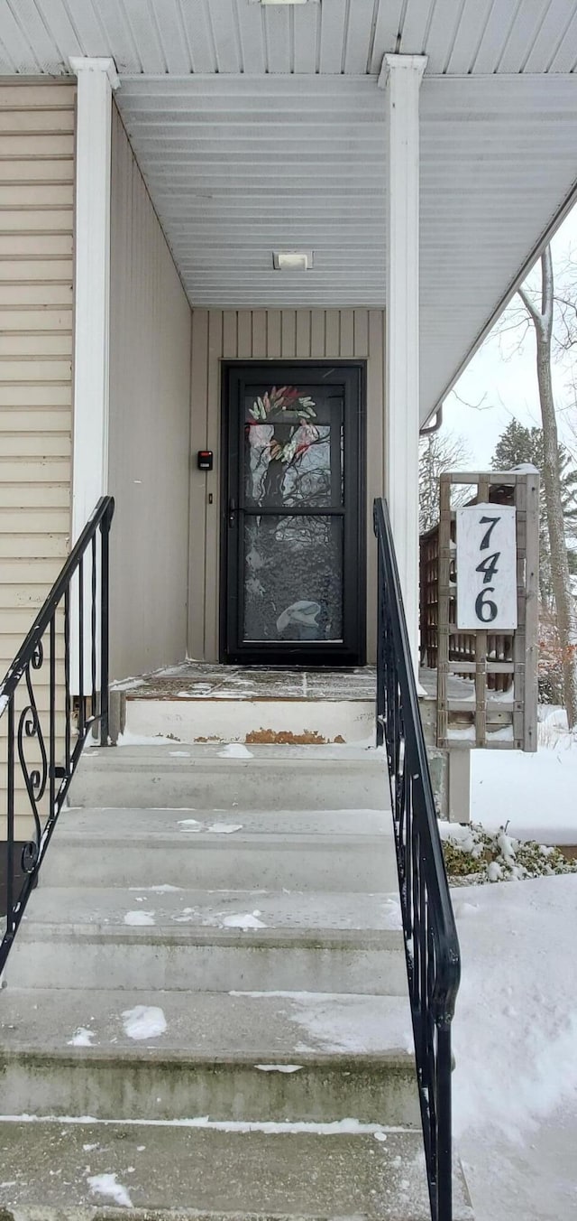 view of snow covered property entrance