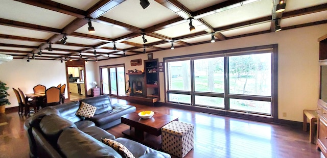 living room with plenty of natural light, baseboards, wood finished floors, and coffered ceiling