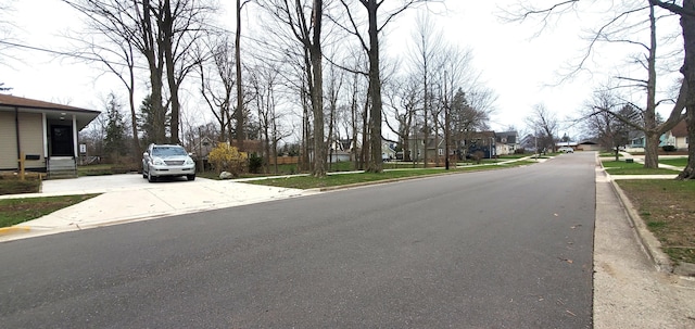 view of road with sidewalks and curbs