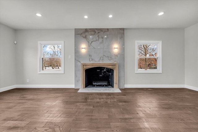 unfurnished living room featuring dark wood-type flooring and a fireplace