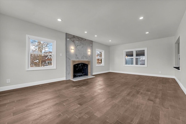 unfurnished living room featuring a fireplace and dark hardwood / wood-style flooring