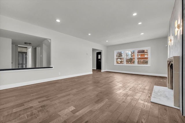 unfurnished living room with wood-type flooring