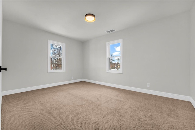 unfurnished room with a healthy amount of sunlight and carpet floors