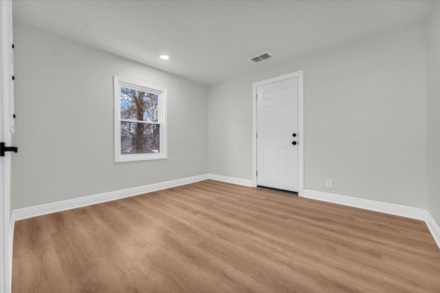 spare room with light hardwood / wood-style flooring