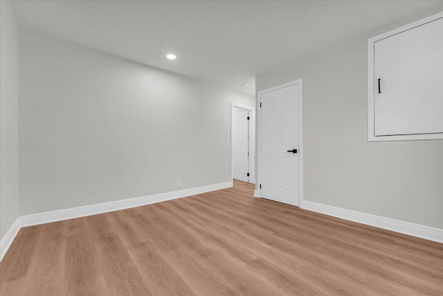 empty room with light hardwood / wood-style flooring