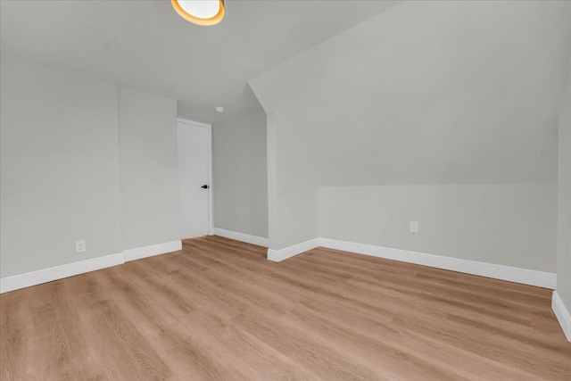 bonus room with lofted ceiling and light hardwood / wood-style floors