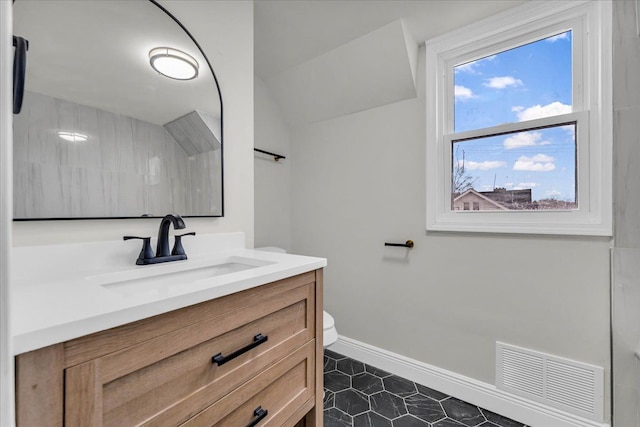 bathroom featuring vanity and toilet