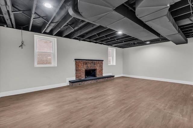 basement with hardwood / wood-style floors and a fireplace