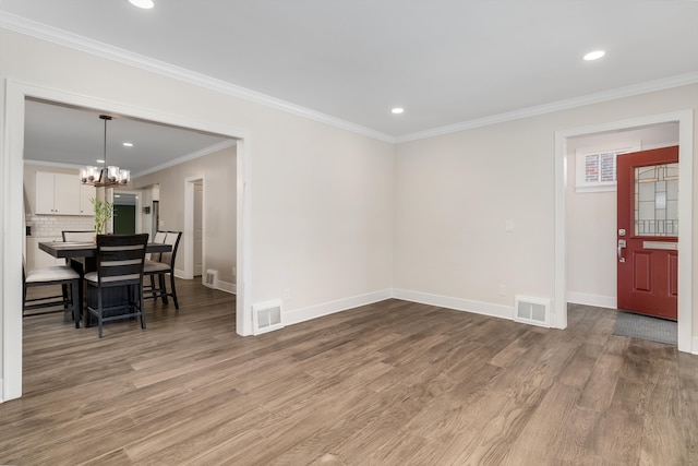 interior space featuring ornamental molding, a chandelier, and hardwood / wood-style floors