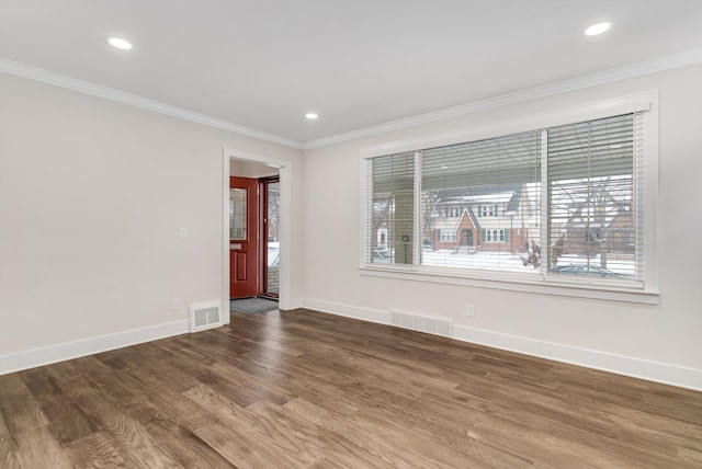 unfurnished room with ornamental molding and hardwood / wood-style floors