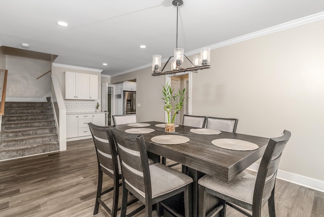 dining space with ornamental molding and dark hardwood / wood-style flooring