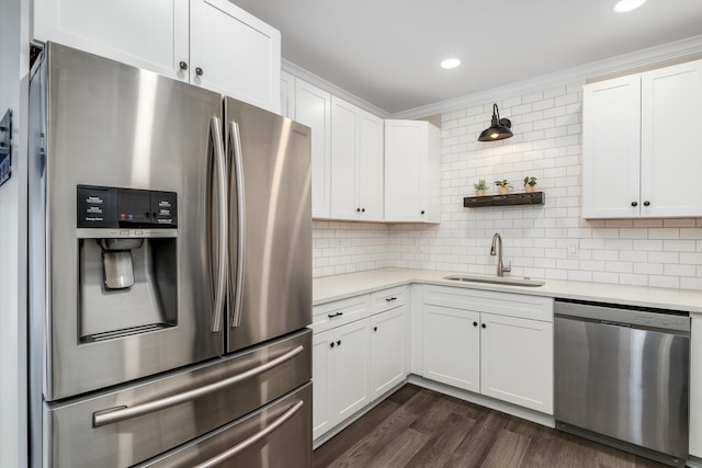 kitchen with white cabinetry, sink, tasteful backsplash, and appliances with stainless steel finishes