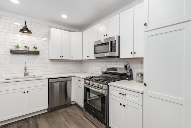 kitchen featuring tasteful backsplash, stainless steel appliances, sink, and white cabinets