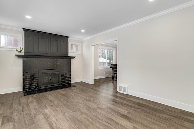 unfurnished living room with dark hardwood / wood-style flooring, crown molding, and a fireplace