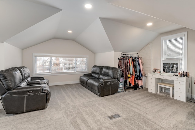 sitting room featuring vaulted ceiling, light carpet, and a wealth of natural light