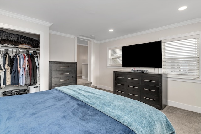 carpeted bedroom featuring crown molding and a closet