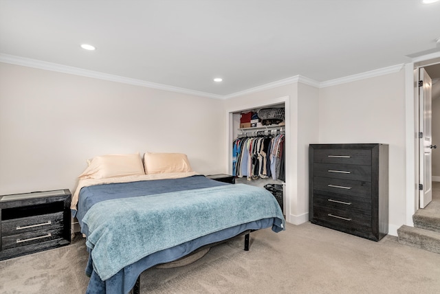 carpeted bedroom with ornamental molding and a closet