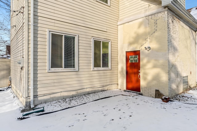 view of snow covered property entrance