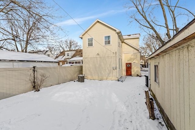 view of snow covered back of property