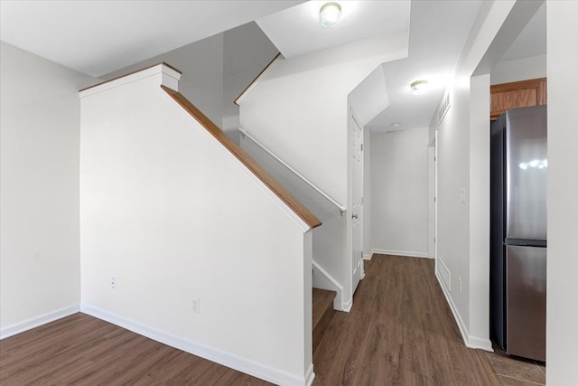 stairway featuring wood-type flooring