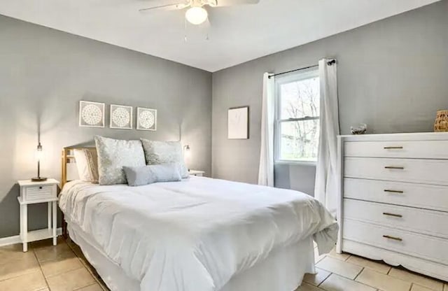 bedroom with ceiling fan and light tile patterned flooring