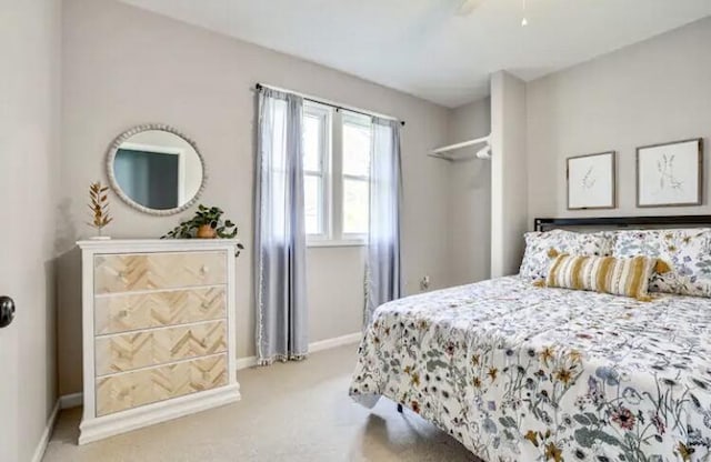 bedroom with light carpet and ceiling fan