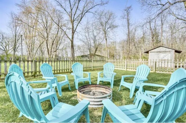 view of patio with a storage shed and a fire pit