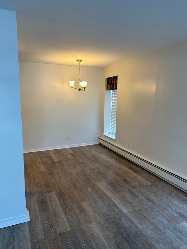 unfurnished room with an inviting chandelier, dark wood-type flooring, and baseboard heating