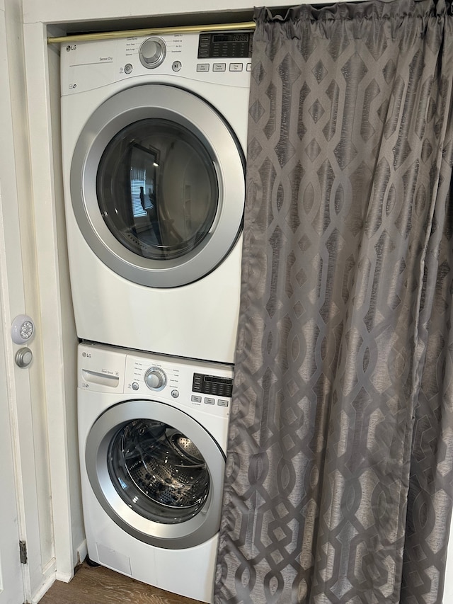 clothes washing area featuring stacked washer / drying machine