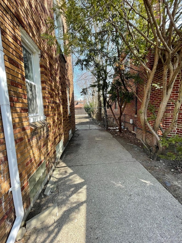 19254 Keystone St, Detroit, MI 48234 - view of side of property featuring crawl space, brick siding, and a gate