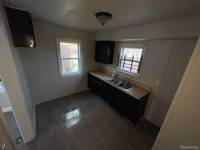 19254 Keystone St, Detroit, MI 48234 - kitchen featuring dark cabinetry, dark wood-type flooring, and light countertops