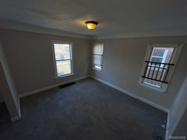 19254 Keystone St, Detroit, MI 48234 - spare room with baseboards and dark carpet